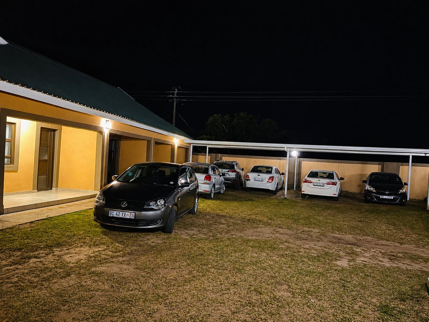 Secure covered parking at Mashobs Guest House at night